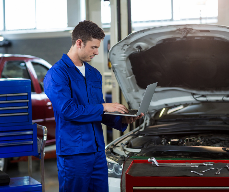 Car mechanic performing routine vehicle maintenance at an auto repair shop in Spokane Valley.